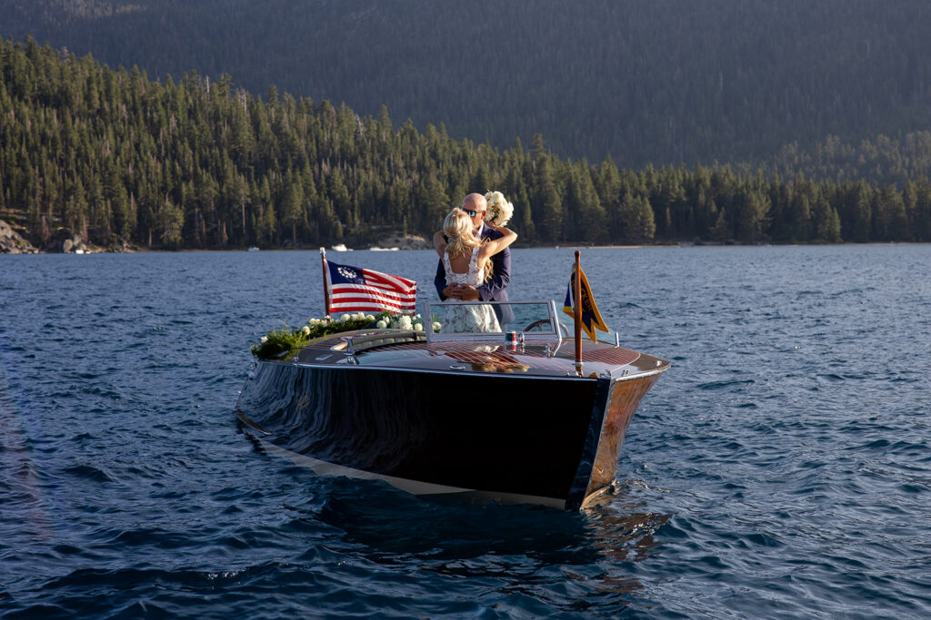 bride and groom kissing on a vintage boat during their lake tahoe elopement