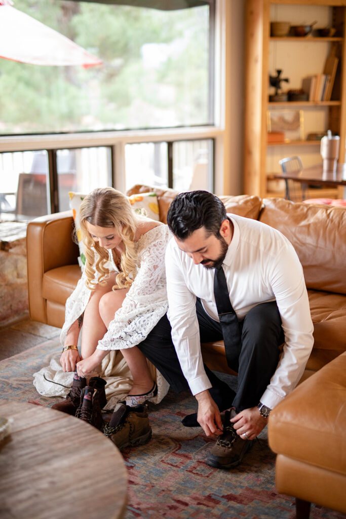 elopement couple tying their hiking boots ahead of their adventure elopement in sedona