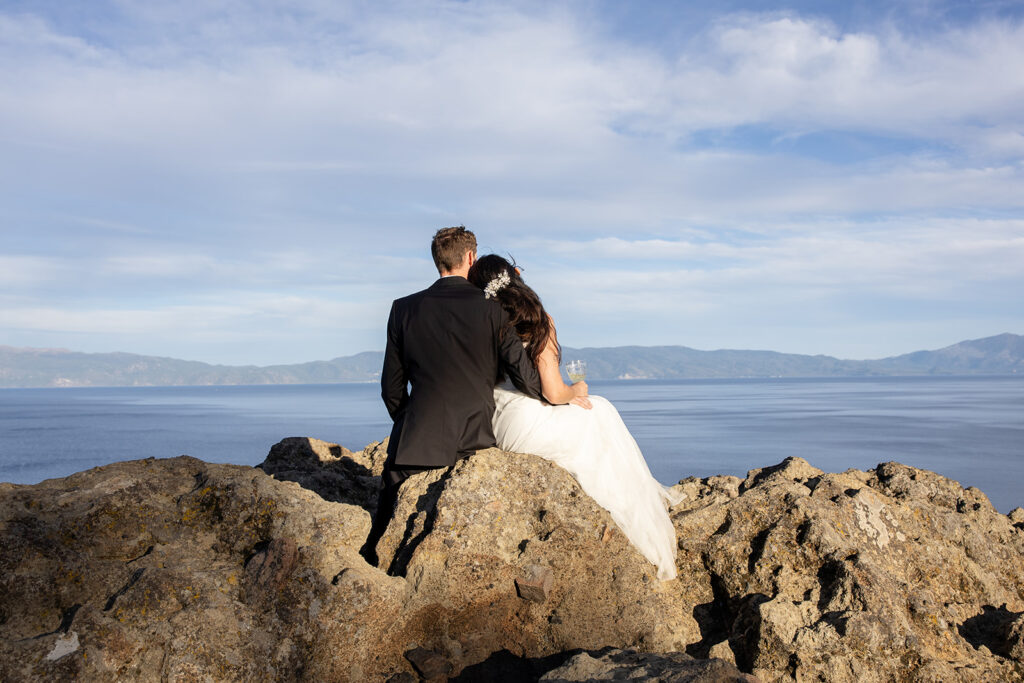 bride and groom enjoying a glass of champagne together during their simple elopement day at lake tahoe