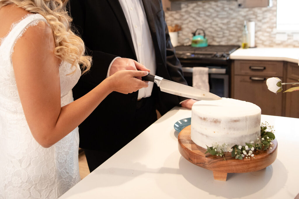 elopement couple cake cutting at their home