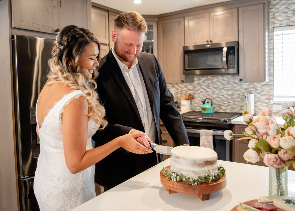 elopement couple cake cutting at their home