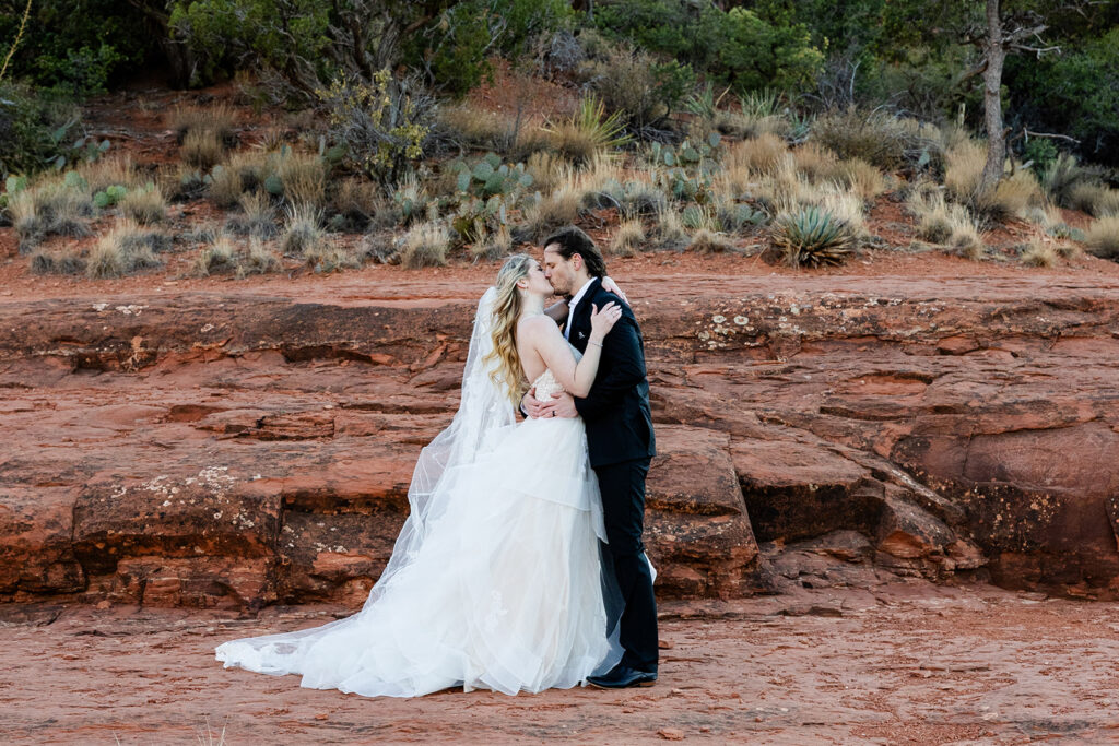 bride and groom kiss as they elope in sedona arizona