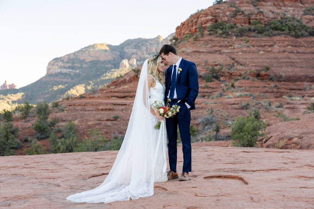 romantic bride and groom in sedona with red rocks in the background