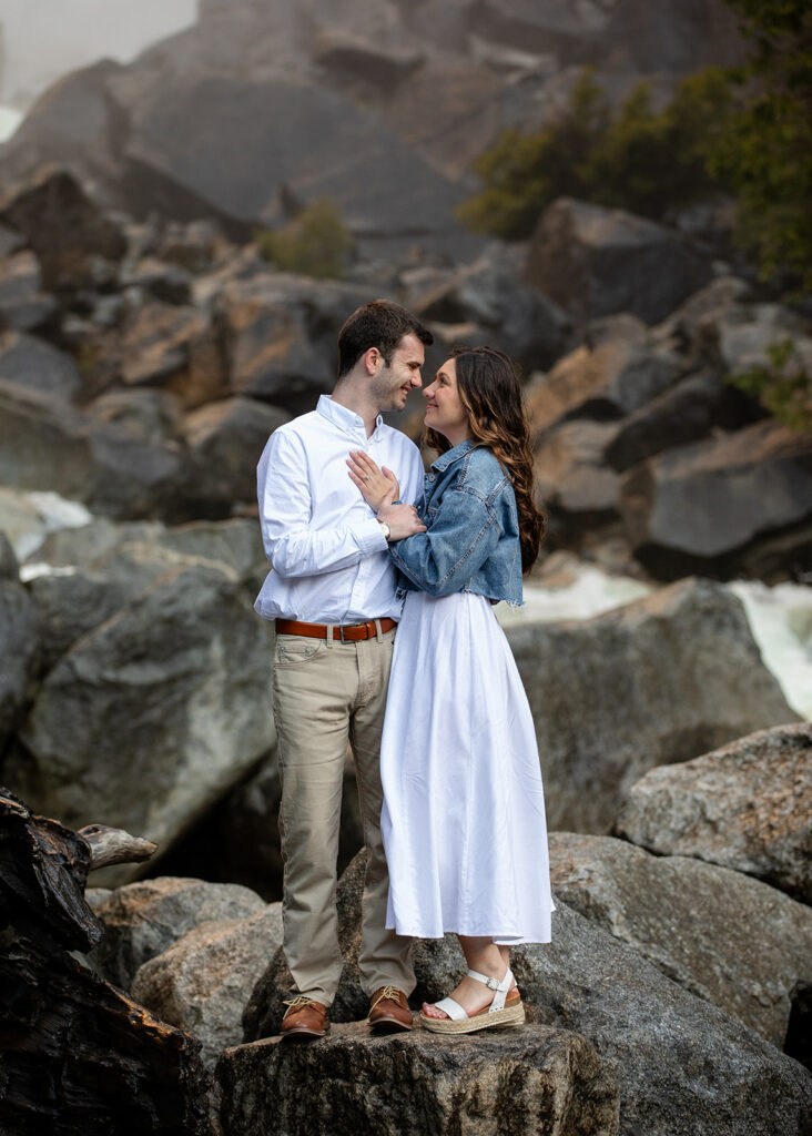adventurous and romantic moments during a Yosemite engagement session with waterfall views