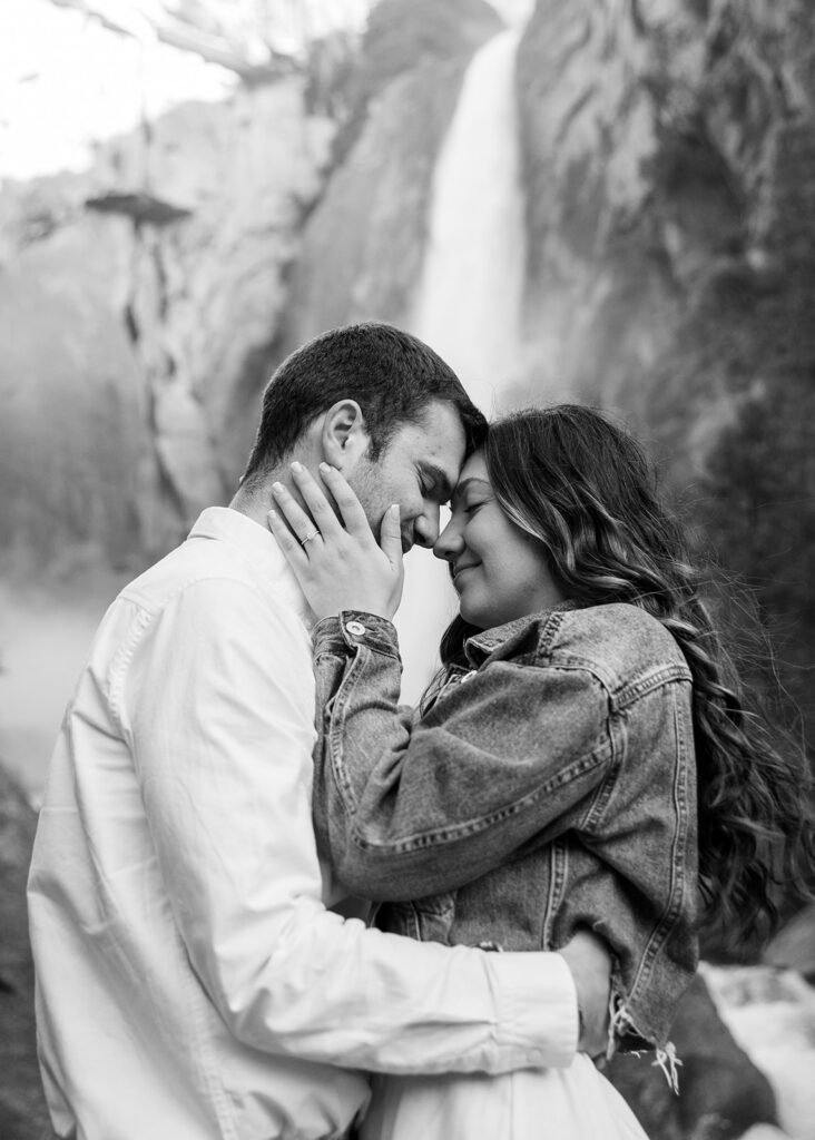 adventurous and romantic moments during a Yosemite engagement session with waterfall views