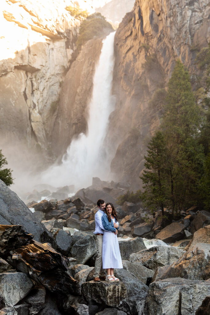 adventurous and romantic moments during a Yosemite engagement session with waterfall views