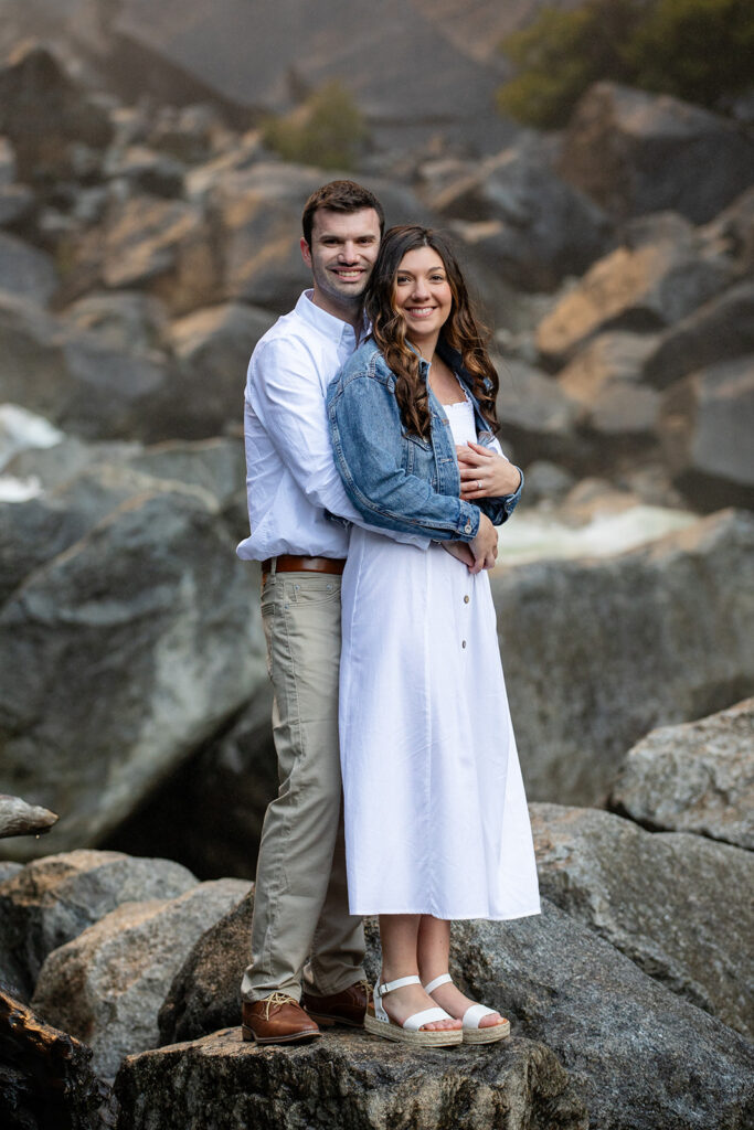 adventurous and romantic moments during a Yosemite engagement session with waterfall views