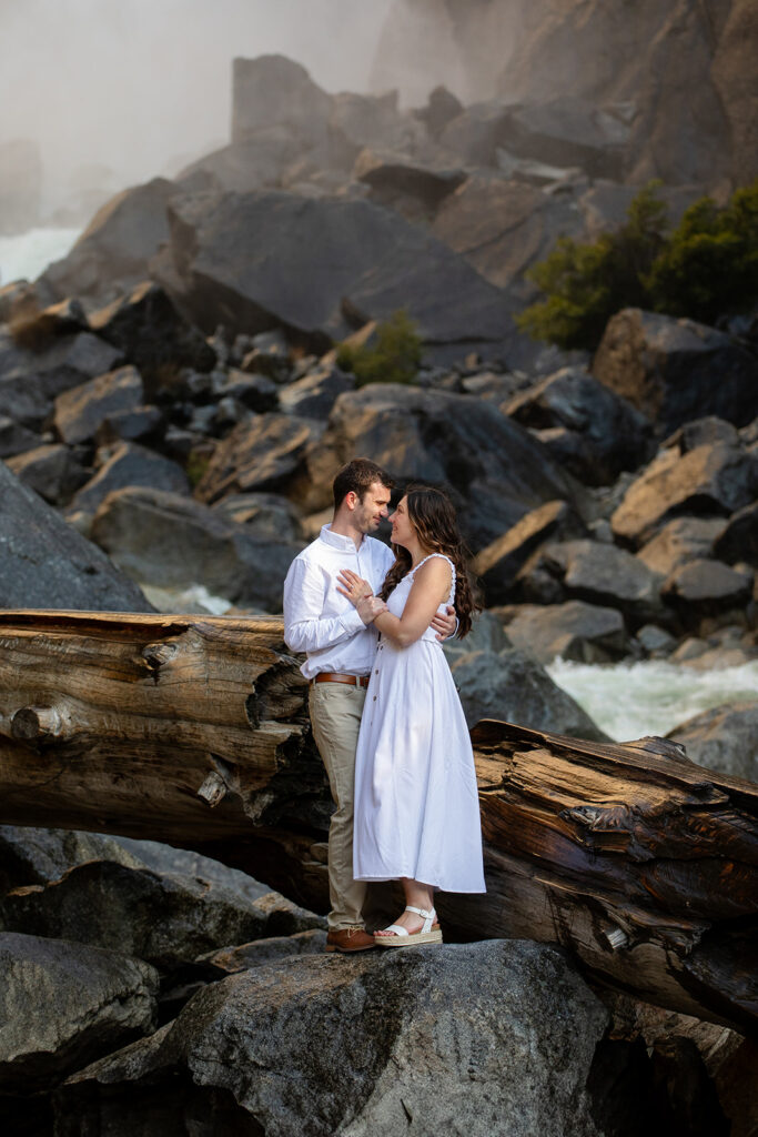 adventurous and romantic moments during a Yosemite engagement session with waterfall views