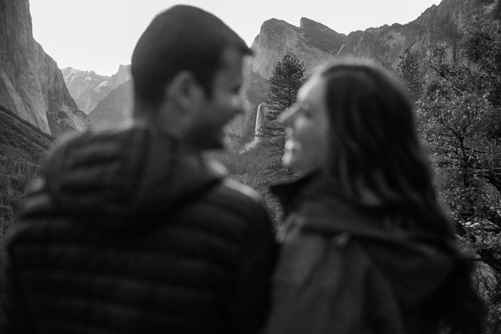 candid Yosemite engagement moment with mountain views