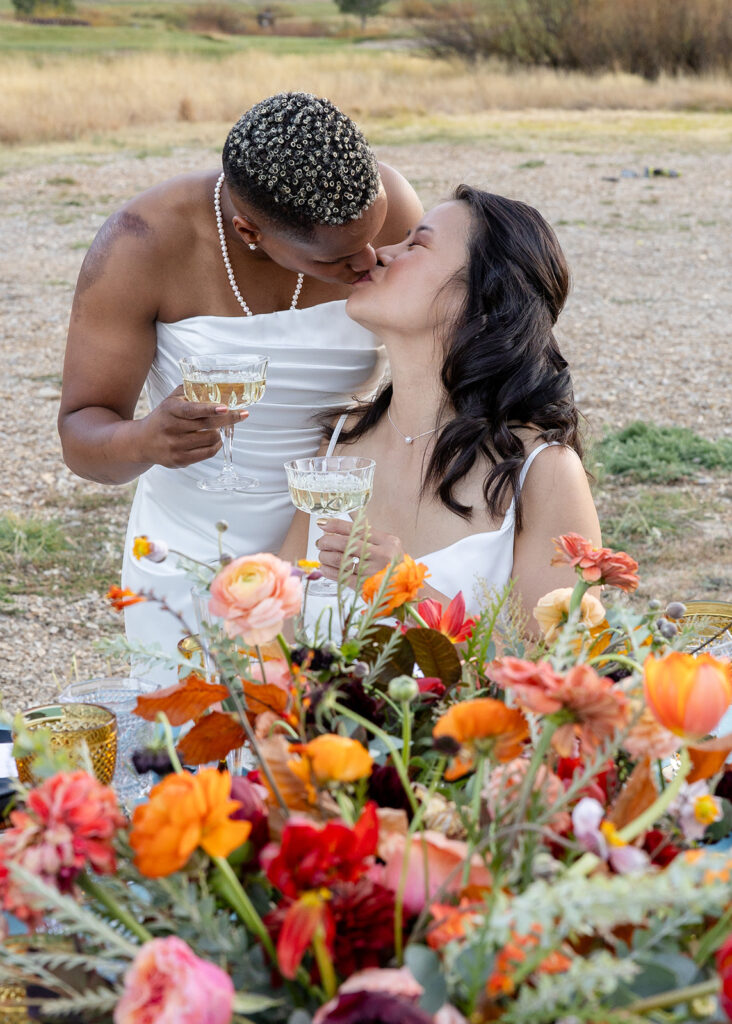 lgbtq couple kissing during a toast