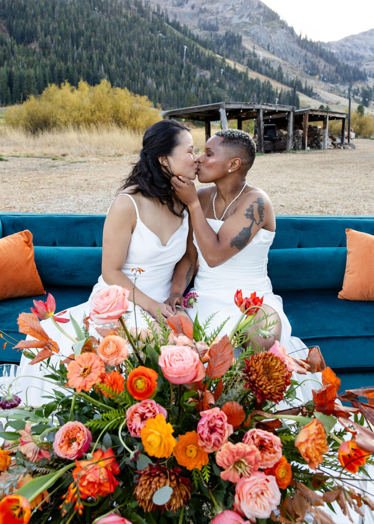 lgbtq couple kissing during their micro wedding at Olympic Valley stables