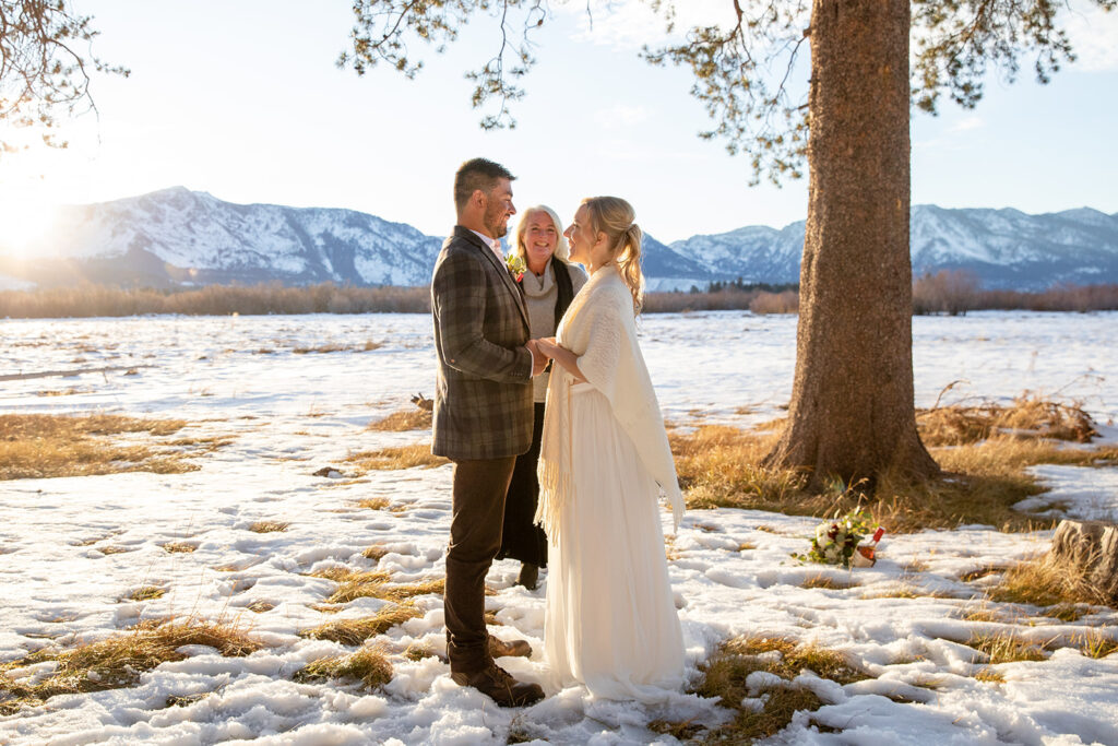 The couple exchanges vows during their intimate winter elopement ceremony in Lake Tahoe