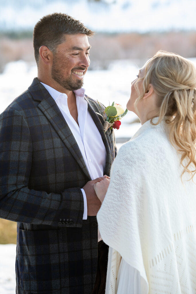 The couple exchanges vows during their intimate winter elopement ceremony in Lake Tahoe