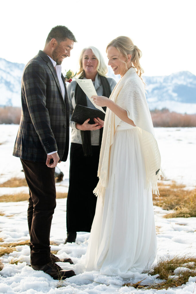 The couple exchanges vows during their intimate winter elopement ceremony in Lake Tahoe
