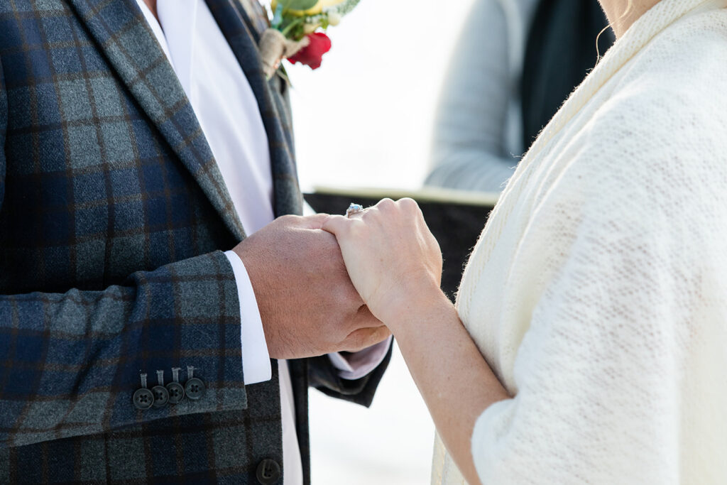 The couple exchanges vows during their intimate winter elopement ceremony in Lake Tahoe