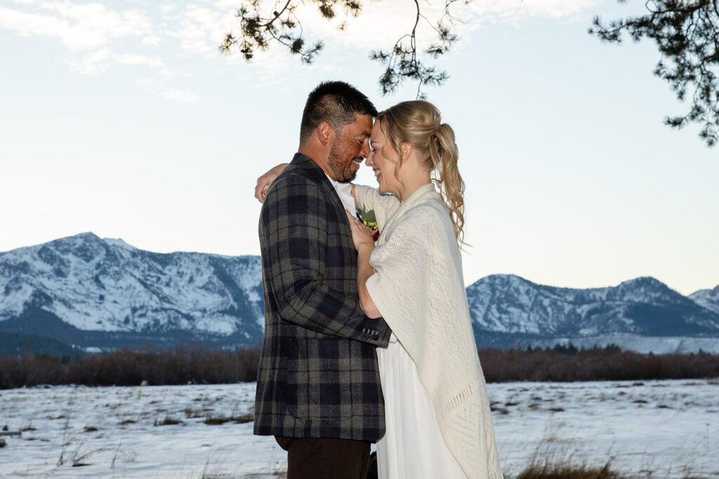 The couple exchanges vows during their intimate winter elopement ceremony in Lake Tahoe