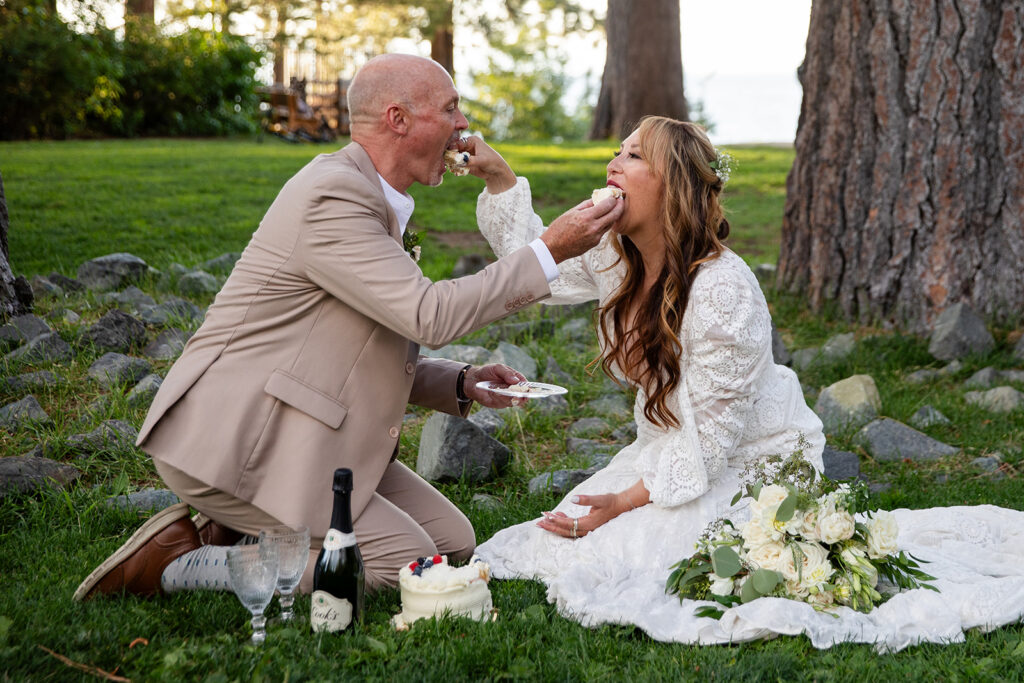 bride and groom cutting a small elopement cake in a park
