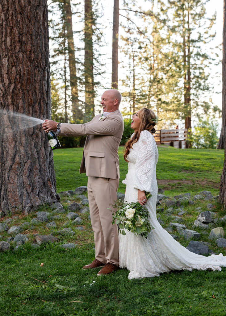 bride and groom popping champagne in Lake Tahoe