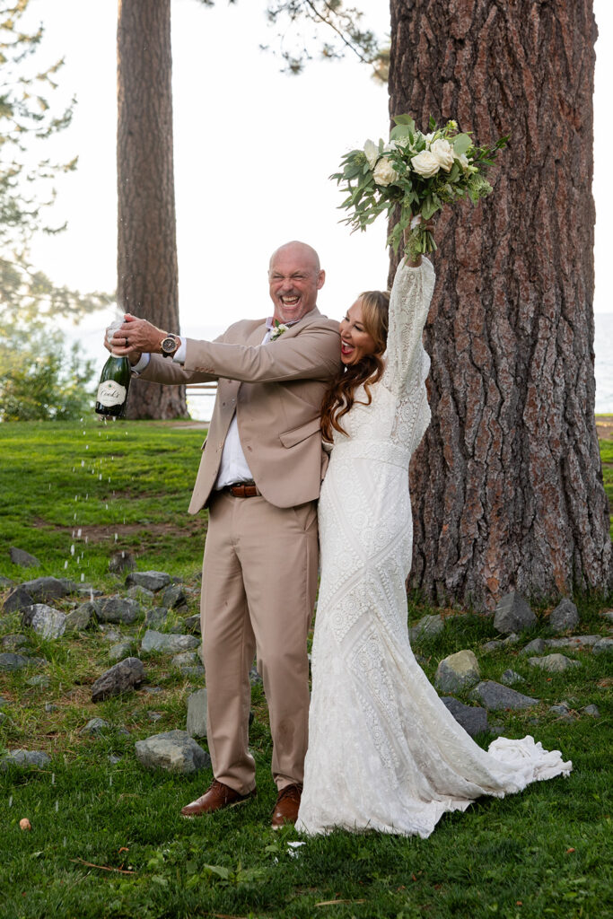 bride and groom popping champagne in Lake Tahoe