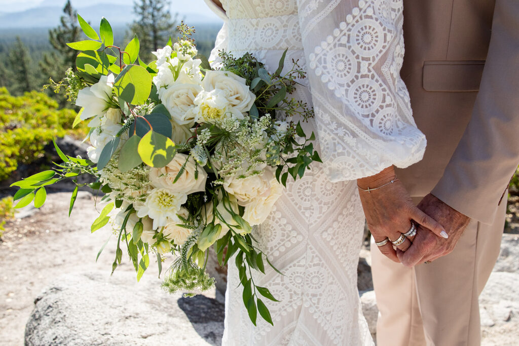 close up of bride and groom holding hands