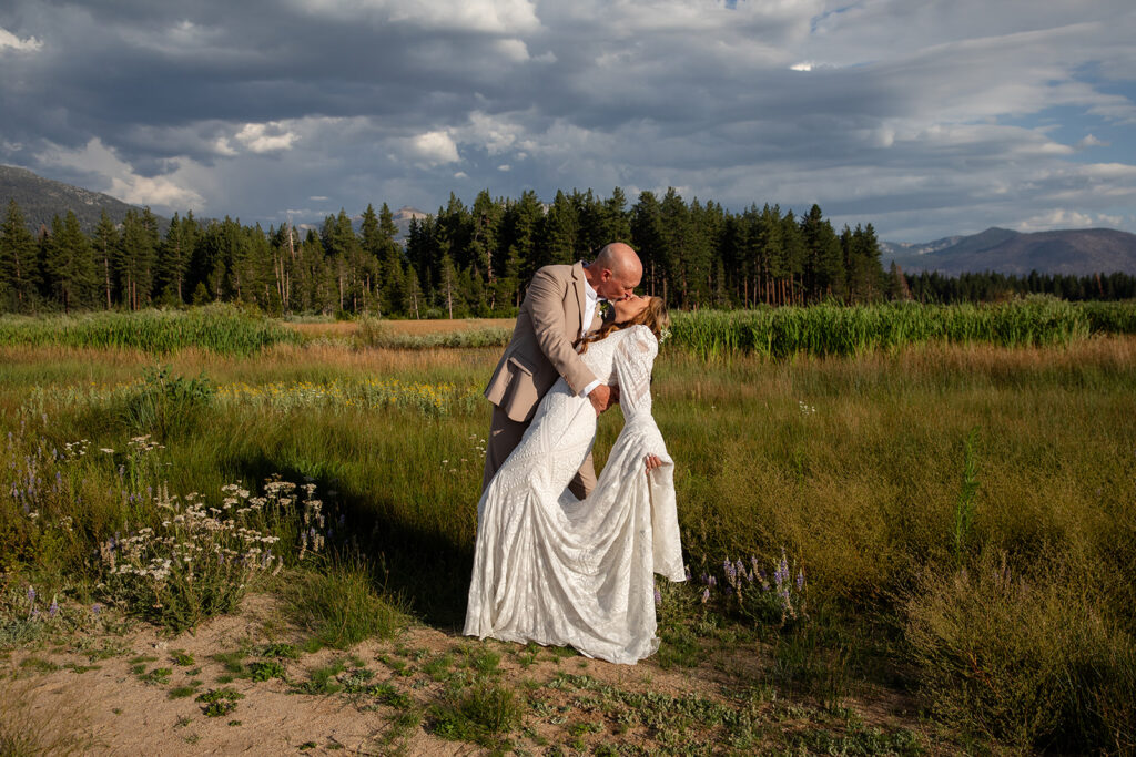 bride and groom dip kiss in a beautiful meadow lake tahoe elopement location