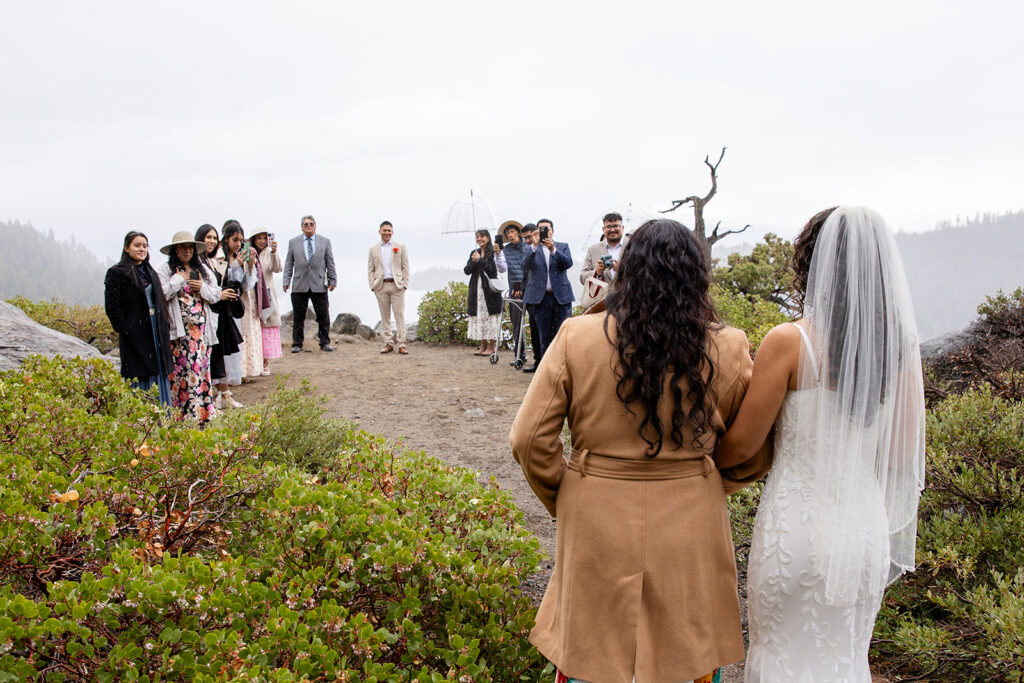 bride and mom walking down the aisle