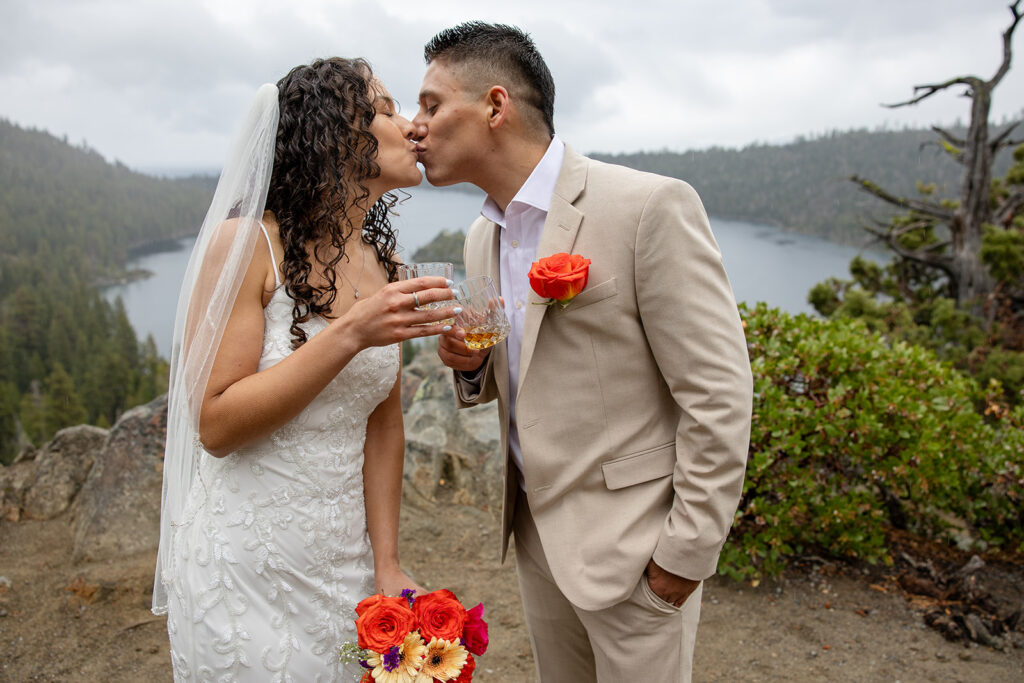 bride and groom kissing in the rain during their emerald bay elopement