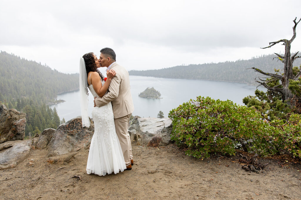 bride and groom kissing in the rain during their emerald bay elopement