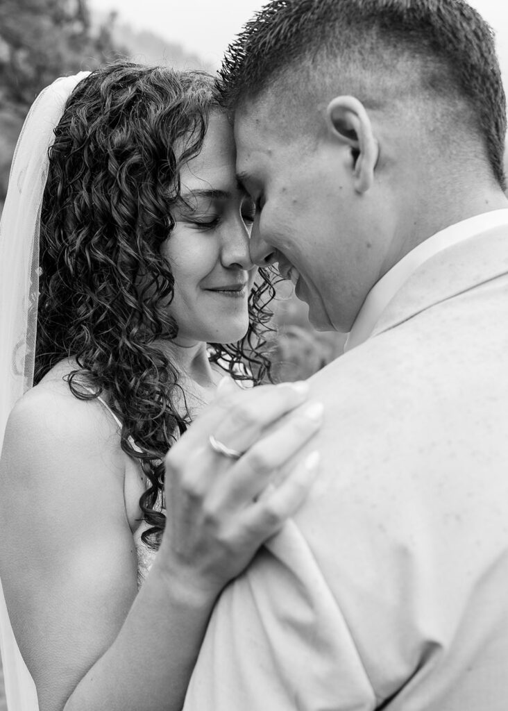 romantic bride and groom moment during a rainy emerald bay elopement in lake tahoe