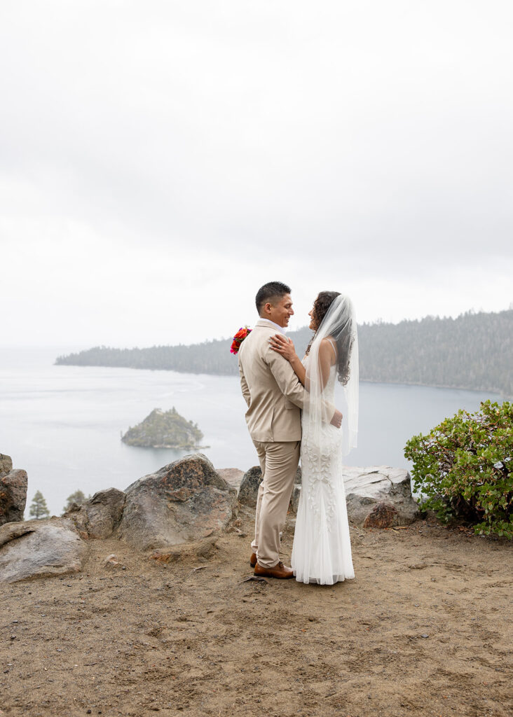 romantic bride and groom moment during a rainy emerald bay elopement in lake tahoe