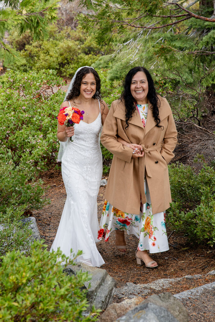 bride and mom walking down the aisle