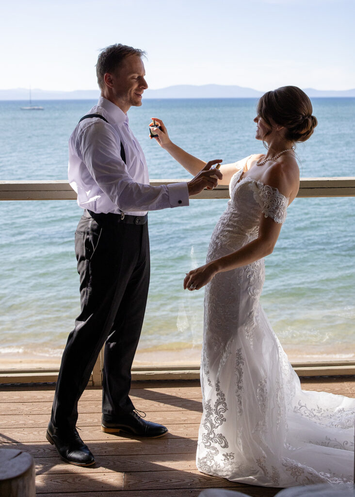bride and groom helping each other get ready at the airbnb