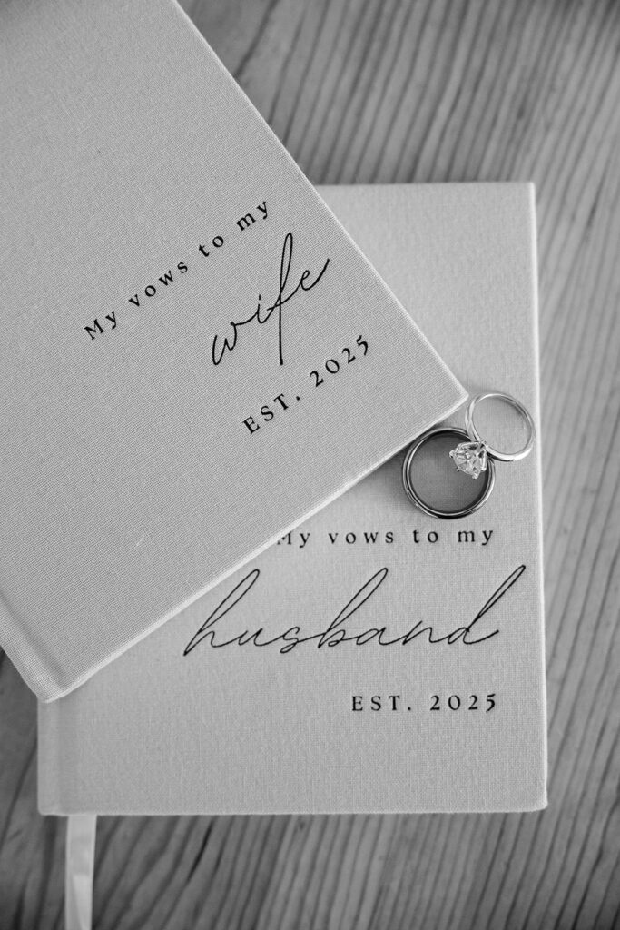 close up of elopement vow books and wedding rings