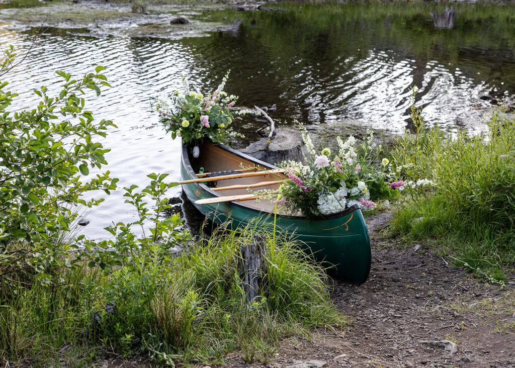 beautifully decorated canoe with flowers for an elopement in lake tahoe