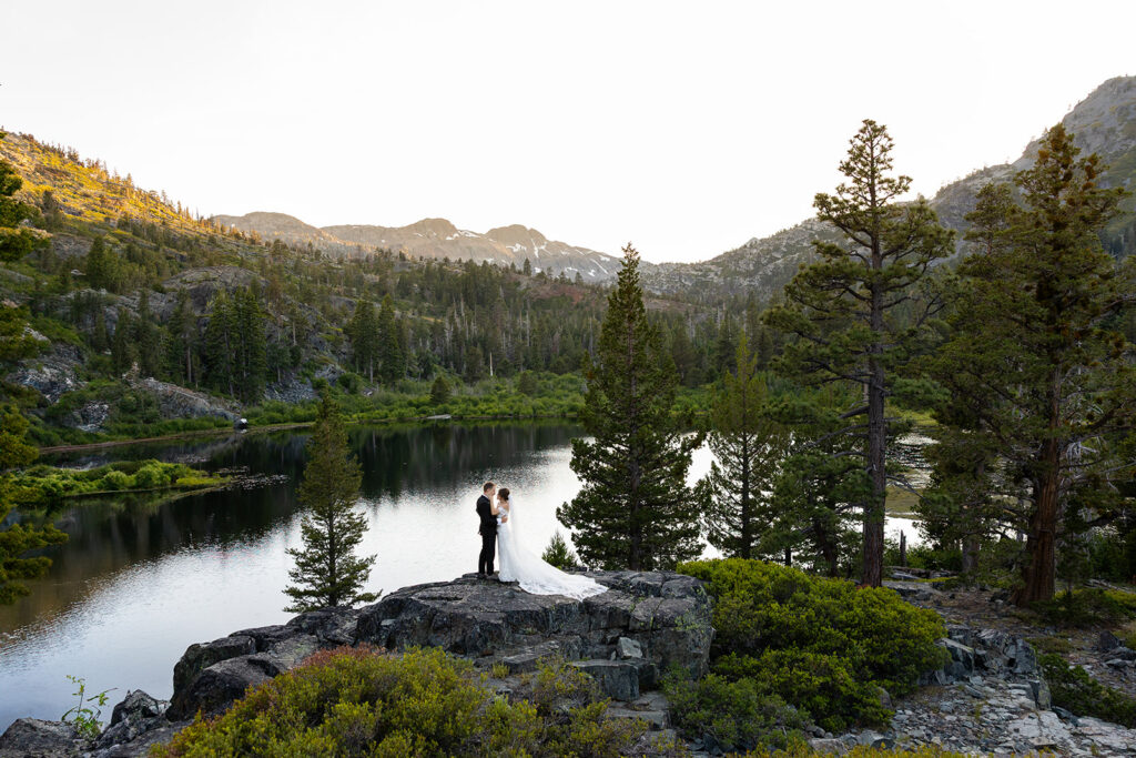bride and groom exchanging vows on a granite cliff overlooking a lake