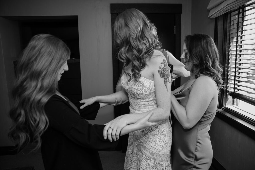 bride getting ready surrounded by family