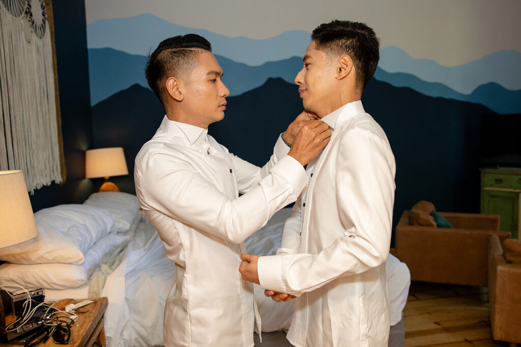 grooms helping each other get ready