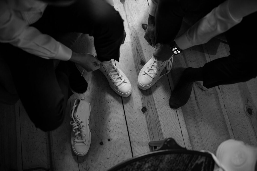 grooms helping each other get ready