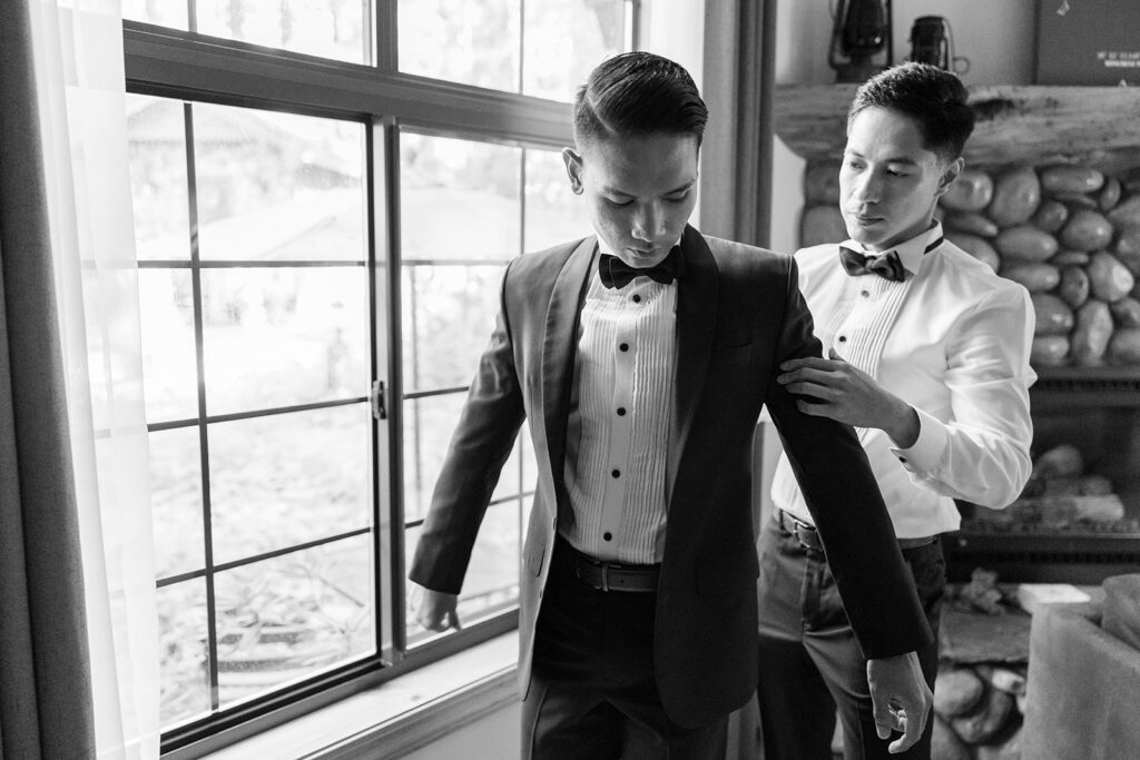 grooms helping each other get ready