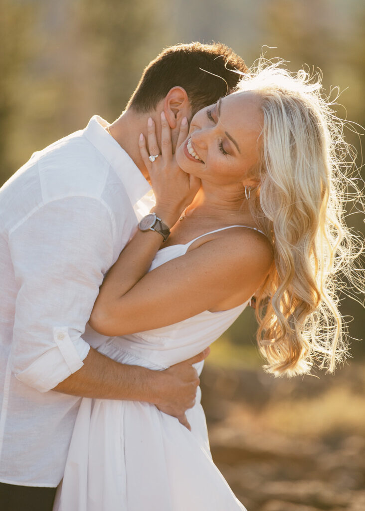 couple hugging during their mountain engagement photoshoot in lake tahoe
