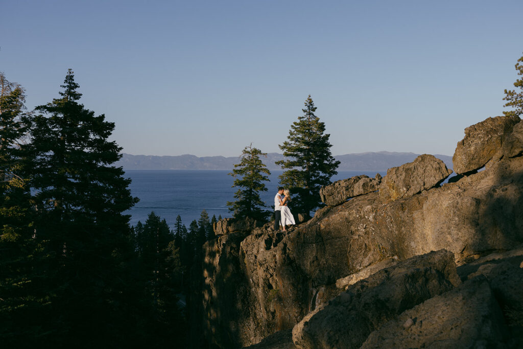 newly engaged couple standing on a rocky mountain engagement session at eagle rock, lake tahoe