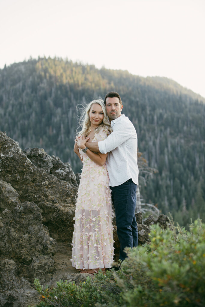 couple hugging during their mountain engagement photoshoot in lake tahoe