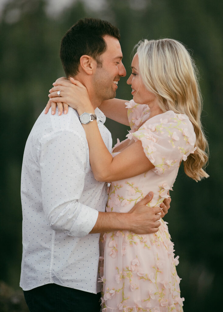 newly engaged couple hugging during their engagement session at eagle rock, lake tahoe