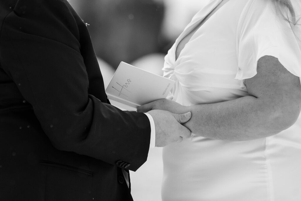 bride and groom exchanging private vows during their snowy spring micro wedding ceremony at lake tahoe 