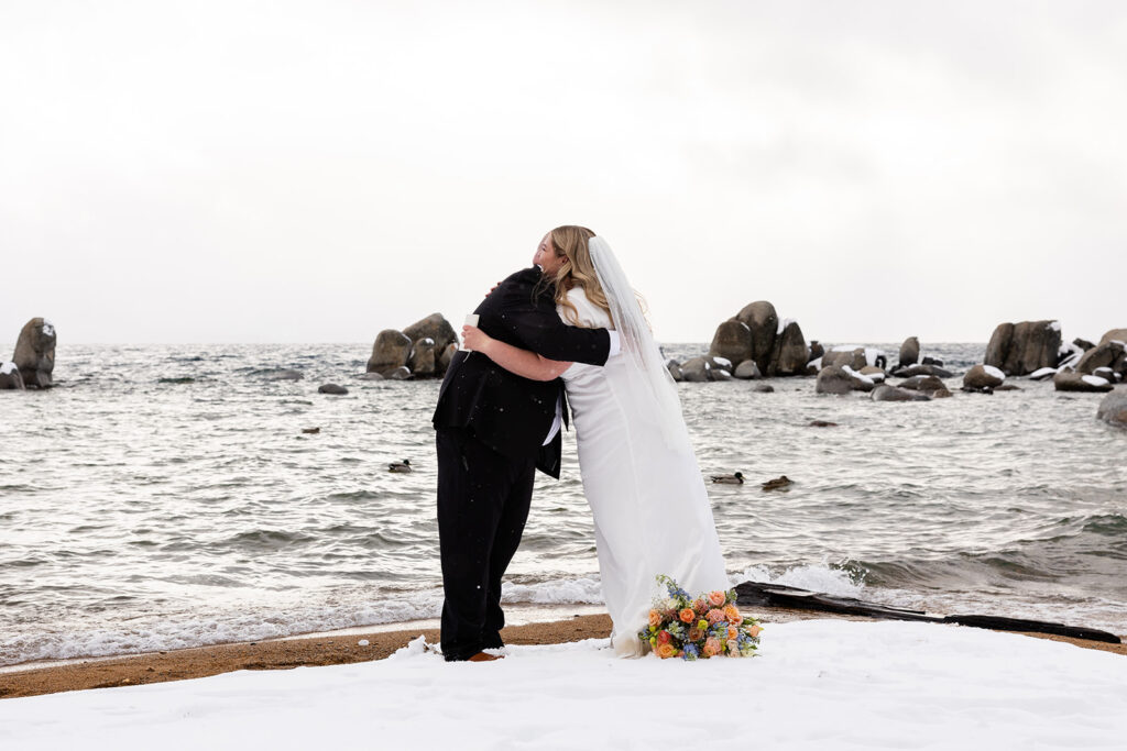 bride and groom exchanging private vows during their snowy spring micro wedding ceremony at lake tahoe 
