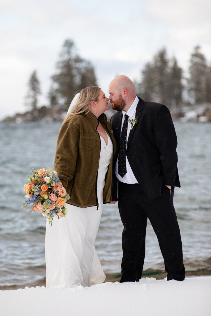 bride and groom kissing during their snowy spring micro wedding in Lake Tahoe