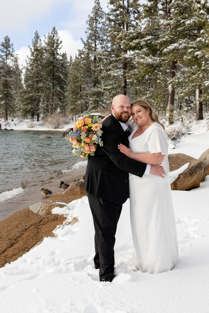 bride and groom hugging during their snowy spring micro wedding in Lake Tahoe