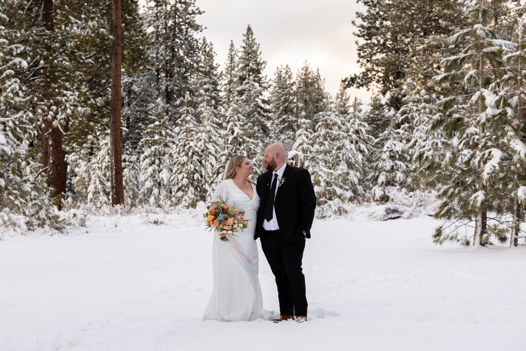 bride and groom looking at each other during their snowy spring micro wedding in Lake Tahoe
