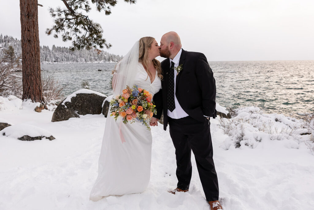 bride and groom kissing during their snowy spring micro wedding in Lake Tahoe