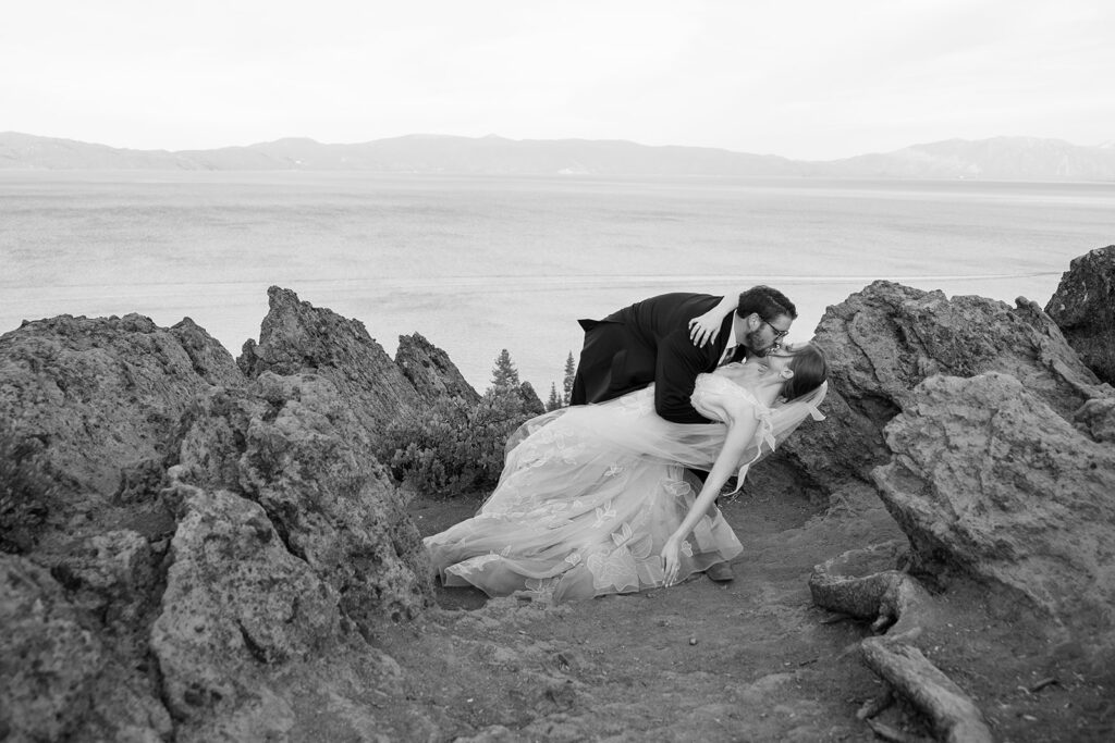 playful bride and groom at a lake tahoe mountain overlook